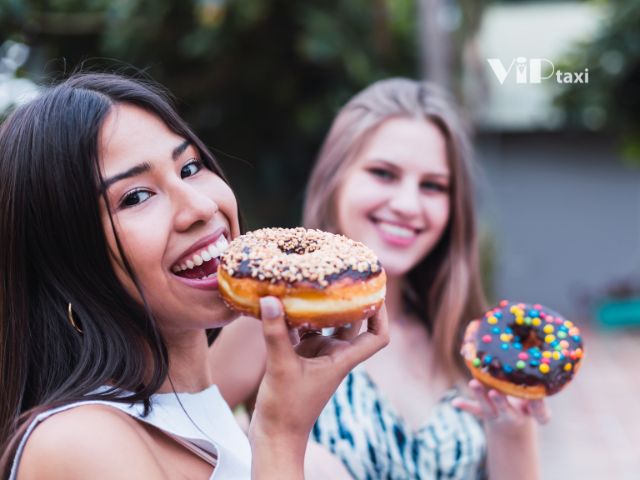 Best Food in Phoenix, AZ Showcasing 2 Women Eating Donuts