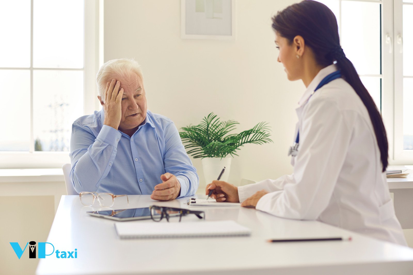 Older Man Discussing Health Concerns With Doctor at Desk