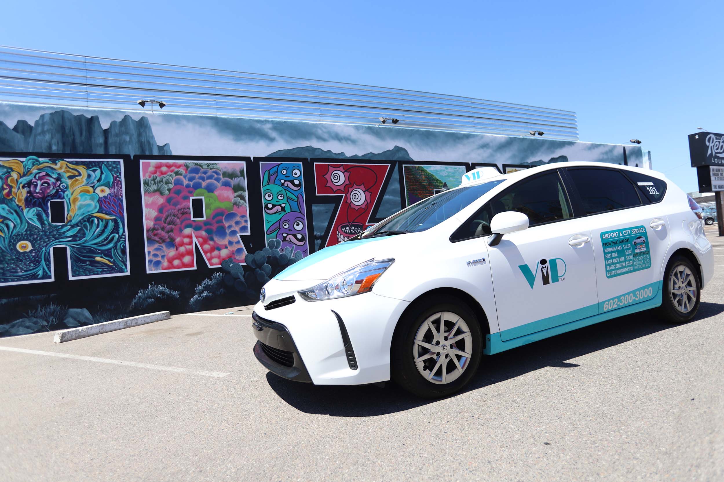 VIP Taxi Parked on a Desert Road with a Large Cactus