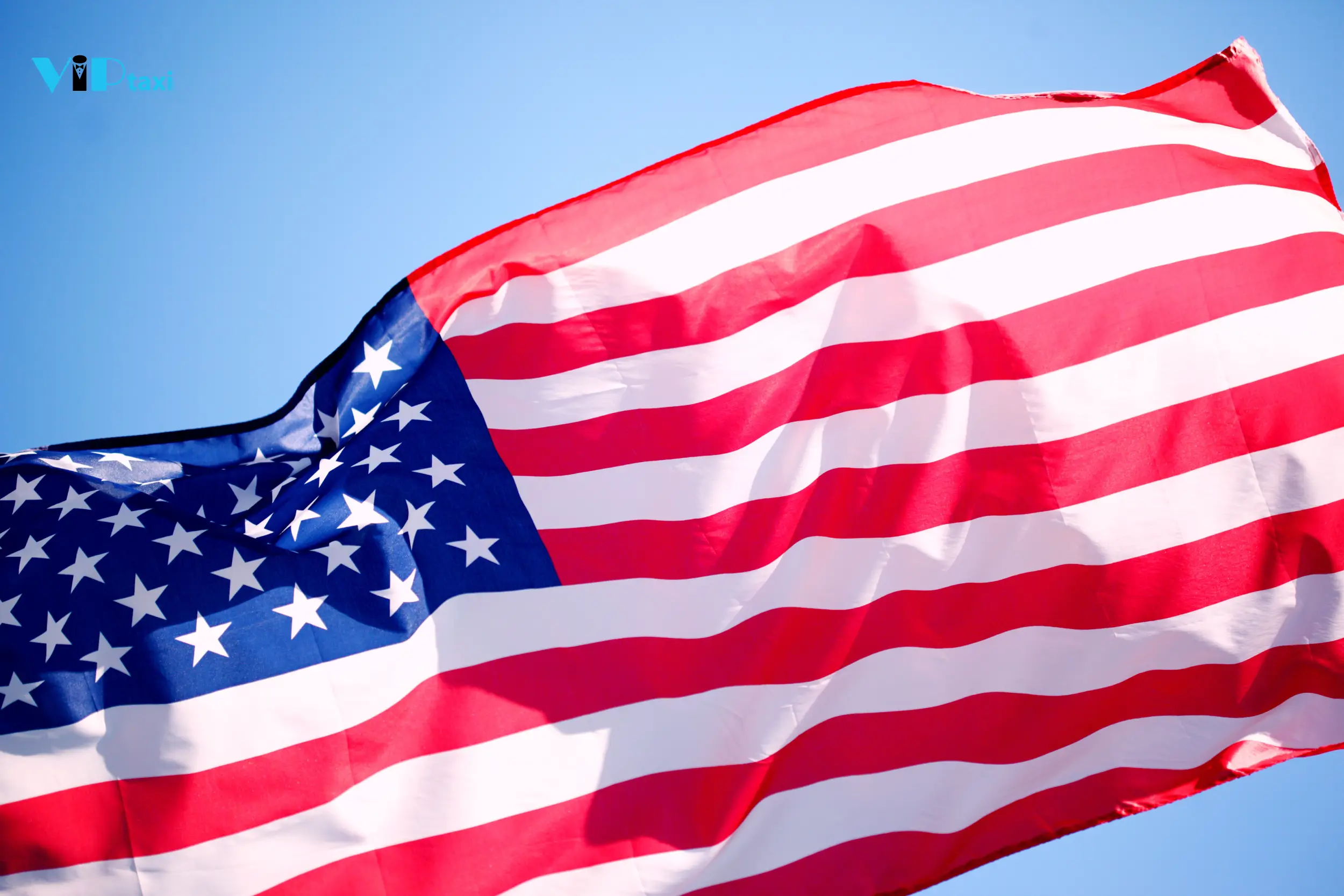 american-flag-waving-blue-sky American Flag Waving Against a Clear Blue Sky